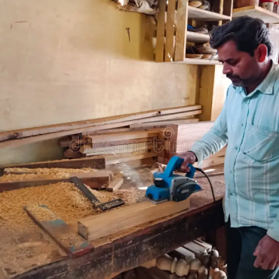 indian-carpenter-chopping-wooden-art-object-factory-india-indian-carpenter-making-wooden-art-object-factory-india-168880369